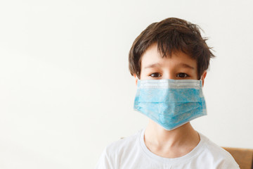 Cute little asian  boy wearing health mask, looking up, isolated over white background