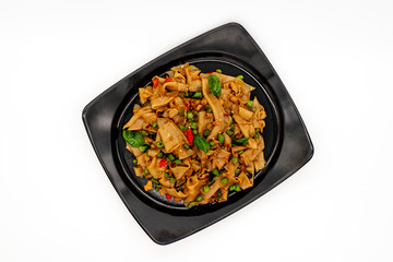Thai Stir fried noodles with chicken, basil and chili on white background