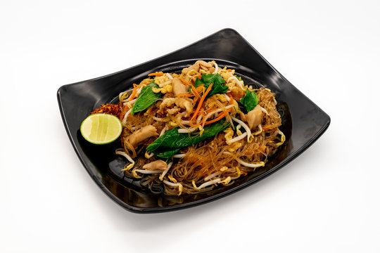 Stir fried rice vermicelli noodle with chicken on white background.