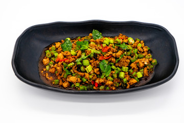 Thai Stir fried pork with basil and chili on white background