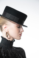 Girl on a white background in a black wool hat
