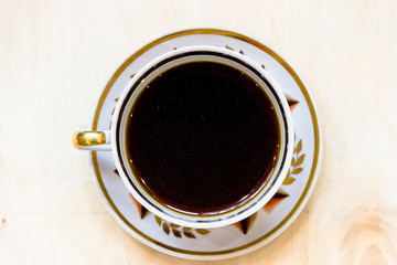 White cup of coffee on vintage wood. Top view