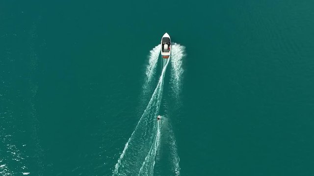 Aerial view of water skiing with motorboat on the sea with blue water. Waterski