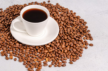 Coffee in a cup with coffee grains