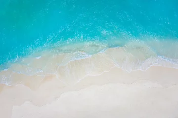 Sierkussen Summer seascape beautiful waves, blue sea water in sunny day. Top view from drone. Sea aerial view, amazing tropical nature background. Beautiful bright sea with waves splashing and beach sand concept © icemanphotos