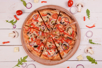 Traditional italian pizza on wooden background.Top view.