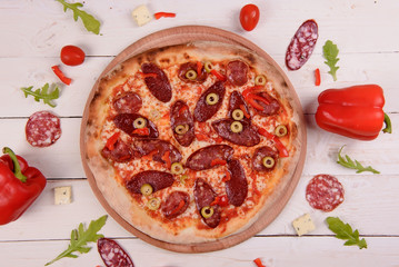 Traditional italian pizza on wooden background.Top view.