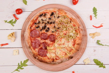 Traditional italian pizza on wooden background.Top view.