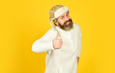 Natural sheep fur. Waiting for warming. Spring is coming. Bearded man wear hat with ear flaps. Furry accessory. Fur garments. Bearded hipster. Winter fashion concept. Warm hat for cold weather