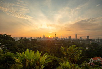 Majestic sunrise over downtown Kuala Lumpur with Petronas Twin Towers and KL Tower still among the significant landmarks and icon for Malaysia.