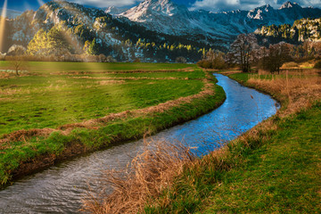  river runs through a valley and in the background are the mountainsv