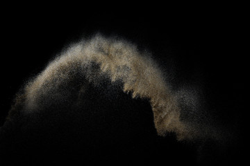 Sandy explosion isolated on black background. Abstract particles cloud. Texture element for design.
