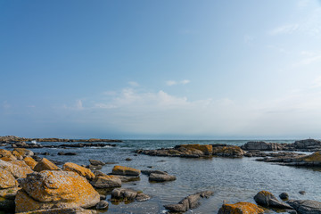 Svaneke, Bornholm / Denmark - July 29 2019: Rocky shore in Bornholm with the baltic sea