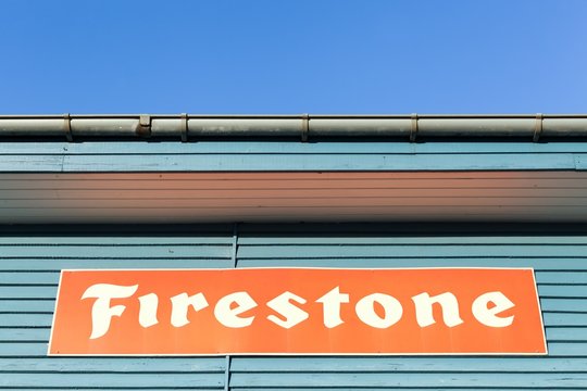 Tilst, Denmark - January 17, 2016: Firestone logo on a building. Firestone is an American tire company founded in 1900 and the company was sold to the Japanese Bridgestone Corporation in 1988