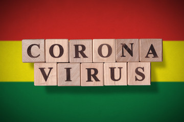 Flag of Bolivia with wooden cubes spelling coronavirus on it. 2019 - 2020 Novel Coronavirus (2019-nCoV) concept, for an outbreak occurs in Bolivia.