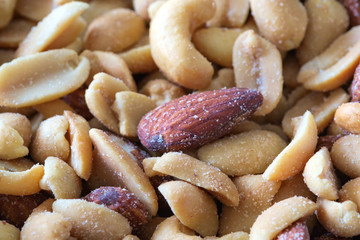 Different nuts salted. Cashew, pistachios, hazelnuts, walnuts, almonds. Close up, selective focus.