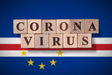 Flag of Cape Verde with wooden cubes spelling coronavirus on it. 2019 - 2020 Novel Coronavirus (2019-nCoV) concept, for an outbreak occurs in Cape Verde.