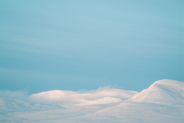 Winter mountains and blue sky