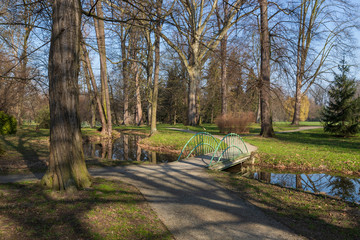 Park through which the river flows. Trees reflecting in the water.