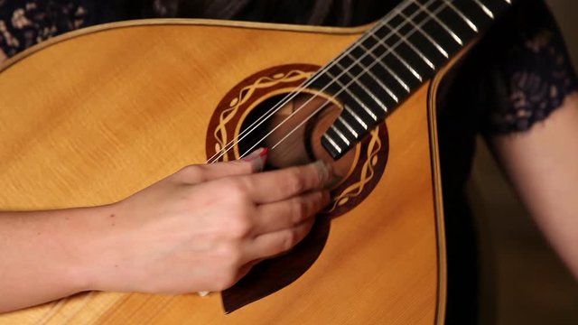 playing twelve steel strings portuguese guitar fado