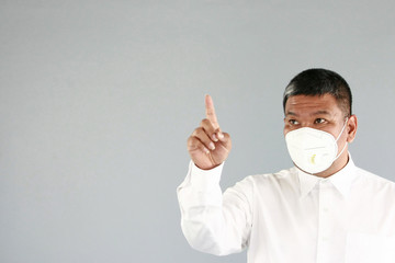 A asian man age 43 years with white shirt , wearing a mask Prevent germs Covid-19 , on gray background