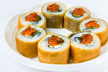 Japanese roll of pancakes with rice, with salmon, cucumber, seaweed and red caviar