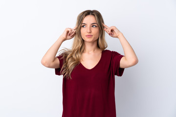 Young woman over isolated white background having doubts and thinking