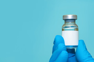 Doctor or nurse hand in medical gloves holds vaccine.Сopy space.The concept of medicine, healthcare and science
