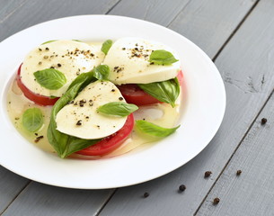 Caprese salad of tomato, mozzarella, basil. Italian food,  copy space