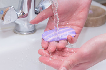 Fototapeta premium A man washes his hands with soap. Close-up photo. Prevention of viral diseases and covid - 19. Keeping your hands clean.