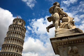 Pisa (PI), Italy - June 10, 2017: The famous Learning Tower of Pisa with an angel sculpture ,...
