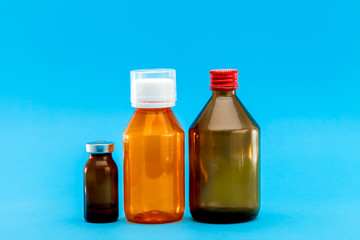 jar with medical disinfectants and a glass bottle for health treatment, pharmacy objects on a blue background with a copy space.