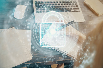 Double exposure of woman's hands writing with lock icon. Concept of security and protection of data