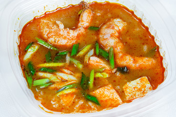 Tomato soup with king prawns and fish with onion feathers