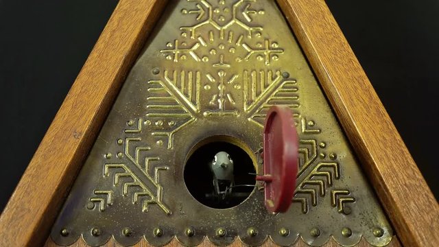 Old Mechanical Clock With A Cuckoo On A White Background.