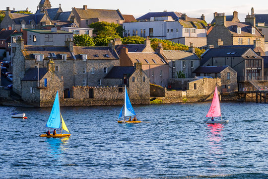 Cityscape in Lerwick with colorful sailboats in the water