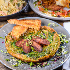 Green Egg Omelette topped with slices of grilled Cacciatore Salami