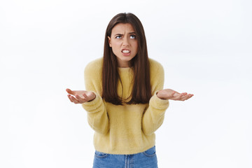 Frustrated and pissed-off angry tensed young woman cursing for bad luck or failure, shrugging with...