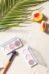 Vacation. A sculpting palette and brush lie on the beach sand, surrounded by vibrant fruits,...