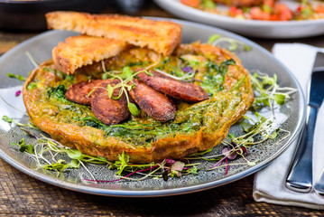Green Egg Omelette topped with slices of grilled Cacciatore Salami
