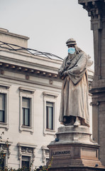 Leonardo statue in Milan wearing a surgical face mask as a symbol of the Milano lockdown caused by coronavirus outbreak
