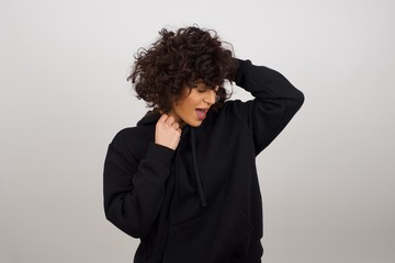 Shot of happy young woman with positive smile, has long hair, rejoices having weekend and good rest after hard working exhausting week, isolated on gray wall.