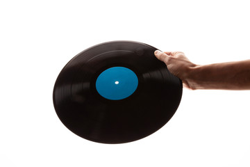 hand holds a vinyl record on a white background