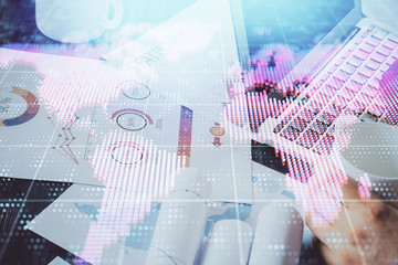 Double exposure of businessman working on laptop on background. International business hologram in front. Concept of success.