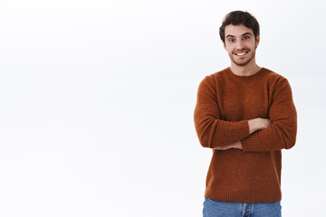 Fototapeta premium Friendly handsome young bearded man, boyfriend found excellent tour for good price, feel proud and satisfied, look pleased camera with beaming happy smile, cross hands over chest accomplished