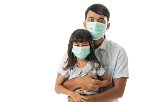 Virus Pandemic. Father And Daughter Wearing Face Masks For Corona Or Covid 19 Protection