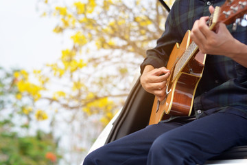 male playing guitar and sing song in a Car