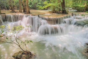 Beautiful soft silky white water flowing on arch rock with green forest background, Huay Mae Khamin Waterfall floor 6th (Dong Pee Sua) Kanchanaburi, west of Thailand.