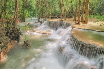 Beautiful soft silky white water flowing on arch rock with green forest background, Huay Mae Khamin Waterfall floor 6th (Dong Pee Sua) Kanchanaburi, west of Thailand.