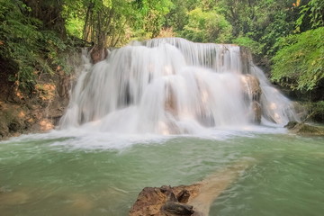 view of white silky water flowing around with green forest background, Huay Mae Khamin Waterfall floor 3th (Wang Nar Pha) Kanchanaburi, west of Thailand.